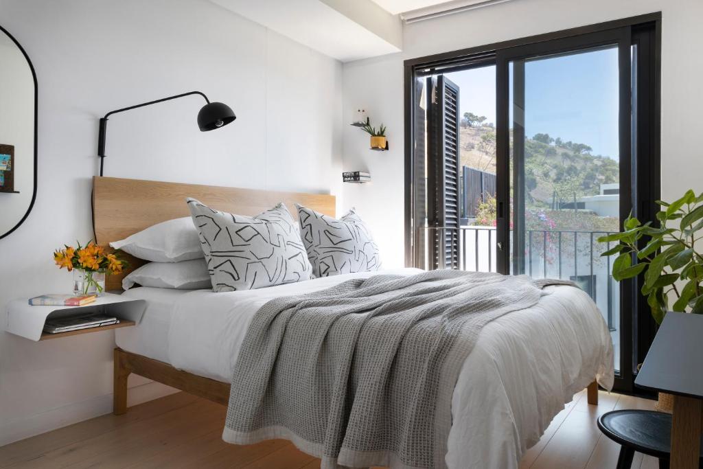 a bedroom with a bed and a large window at Old Cape Quarter - Cape 8 Collection in Cape Town