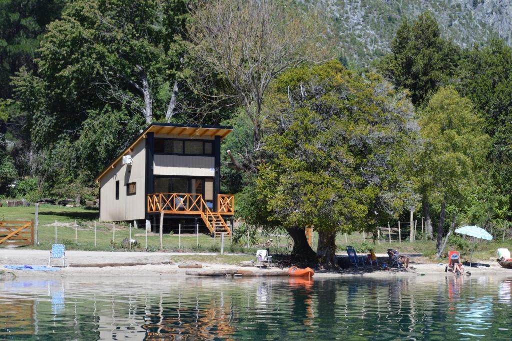 una cabaña a orillas de un cuerpo de agua en Cabaña Don Ramon - Puerto Patriada, en El Hoyo