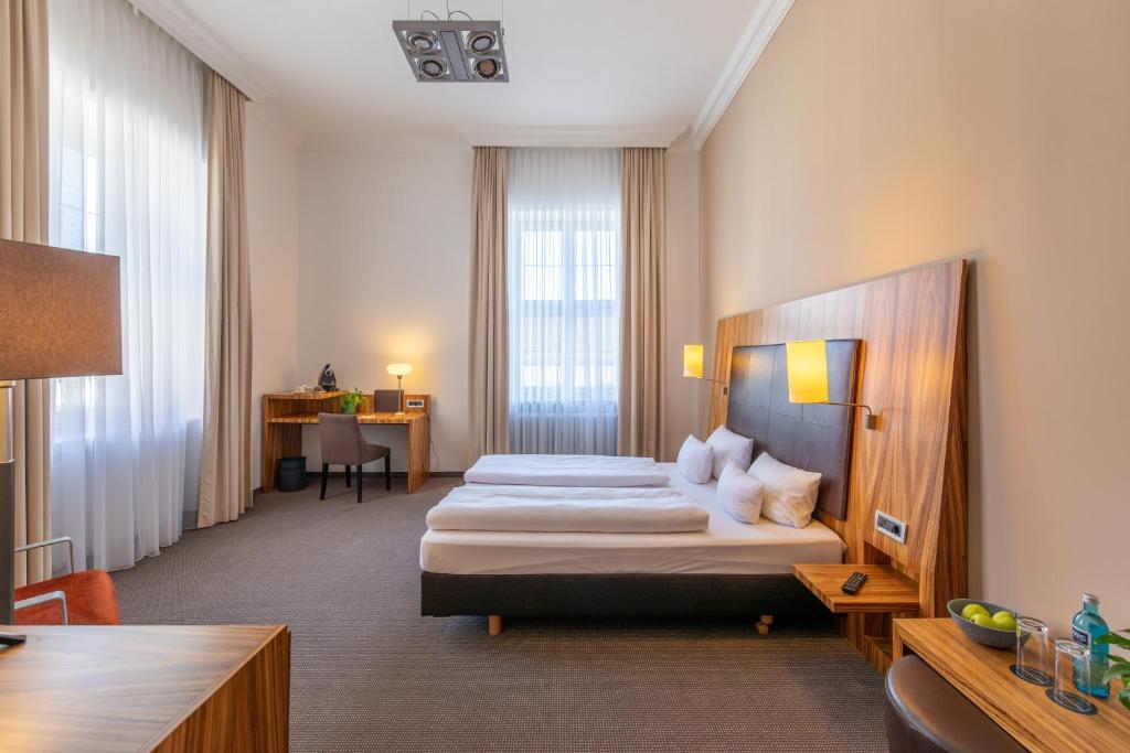 Postel nebo postele na pokoji v ubytování Herzogshof - Boutique-Hotel am Dom