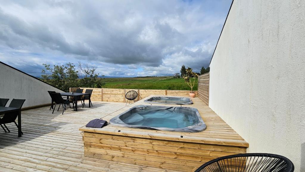 a hot tub sitting on top of a wooden deck at Hótel Skálholt in Golden Circle in Skálholt