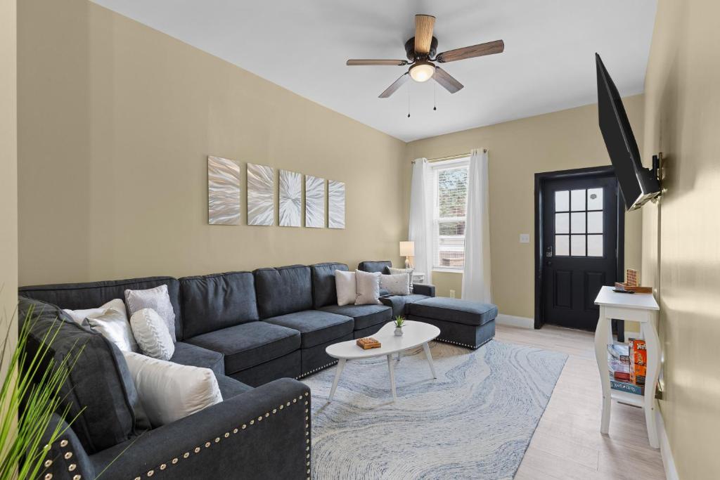 a living room with a couch and a table at Red Brick Hideaway in Soulard