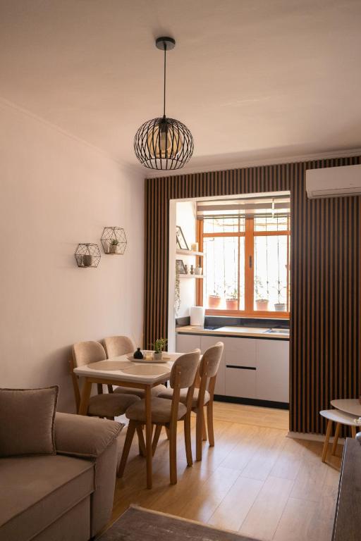 a living room with a table and a kitchen at Radeshi House in Berat