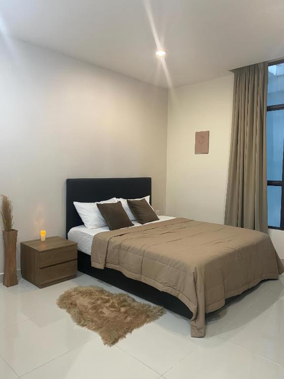 a bedroom with a large bed and a window at Kozi Square, Kozi 8 in Kuching