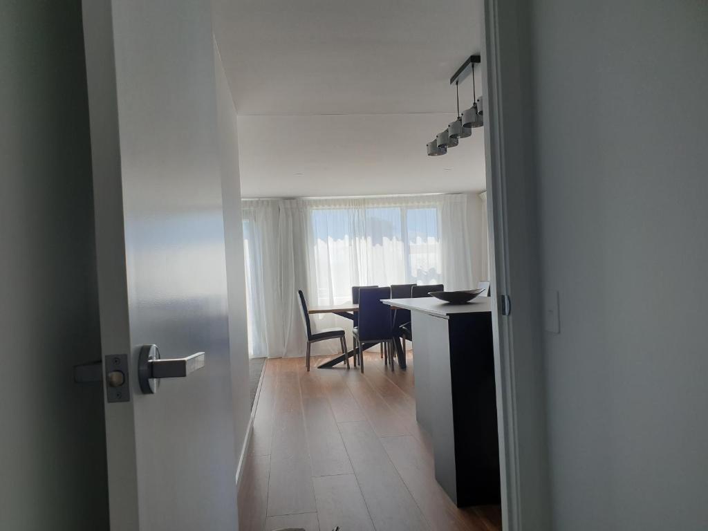a white room with a table and chairs and a door at Mathea House in Richmond