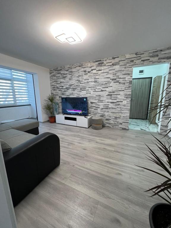 a living room with a couch and a flat screen tv at ADI-RENTS Apartmens in Giurgiu