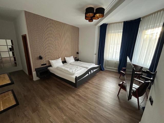 a bedroom with a bed and a desk in it at Parkhotel Rottweil in Rottweil