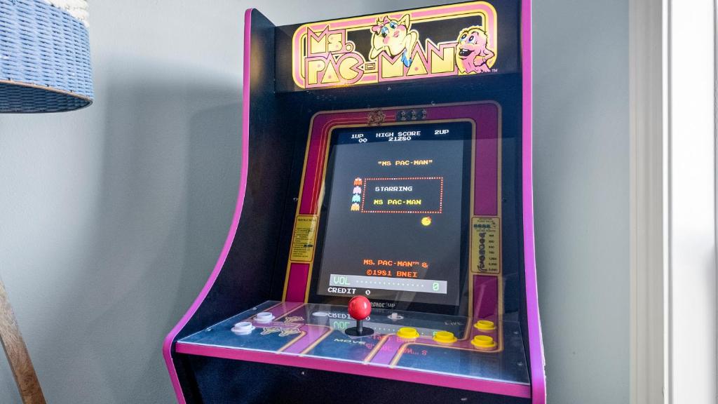 a video game machine in a room at Seaside Sunrise Luxury Beachfront, Hot Tub, Firepit, Elevator in Port Bolivar