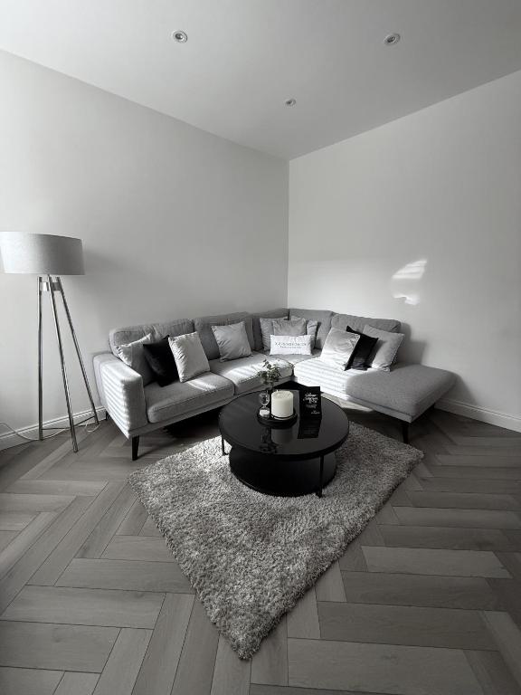 a living room with a couch and a table at A home away from home in Manchester