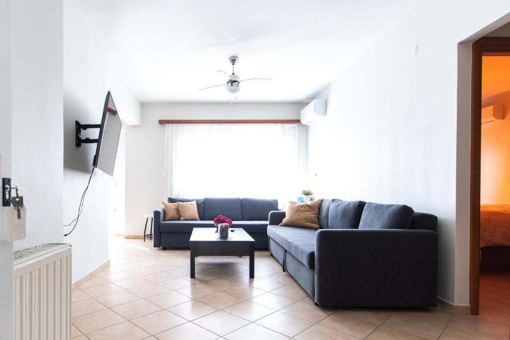a living room with a couch and a table at Igoumenitsa View - Marinos in Igoumenitsa