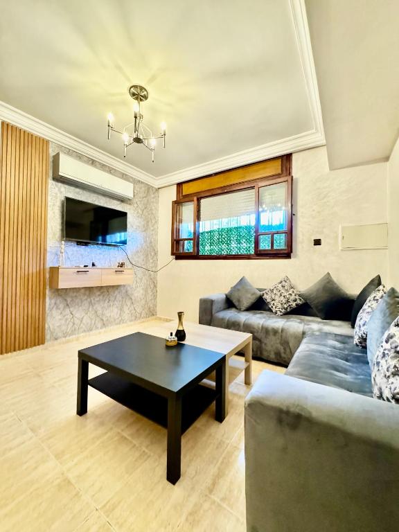 a living room with a couch and a table at Atlas appartement in Fez