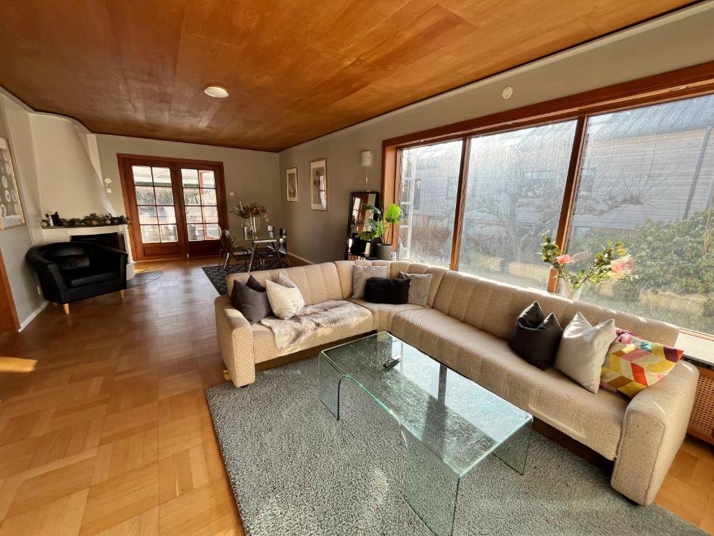 a living room with a couch and a glass table at Charming Guest House in Oslo City 4 in Oslo