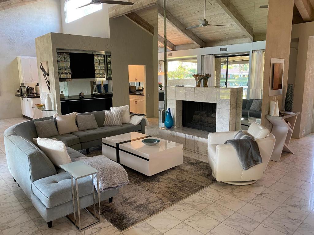 a living room with a couch and a fireplace at Cloud Nine in Rancho Mirage