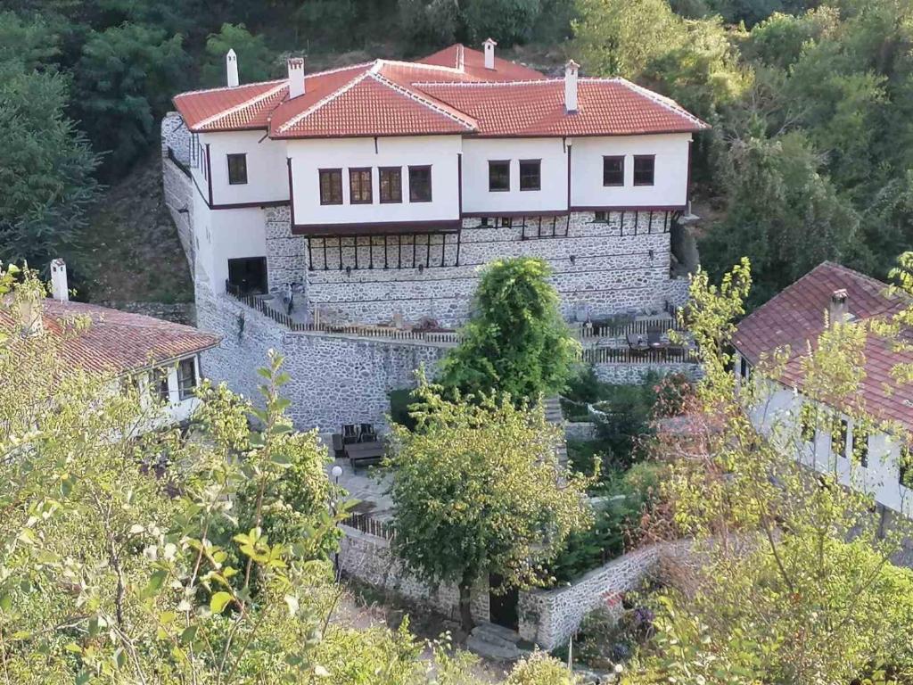 a large white house with a red roof at Velev House in Melnik