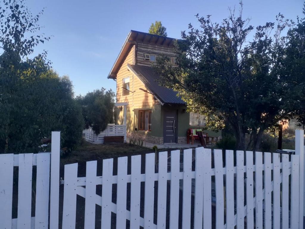 a white picket fence in front of a house at Lo de Pere in San Carlos de Bariloche