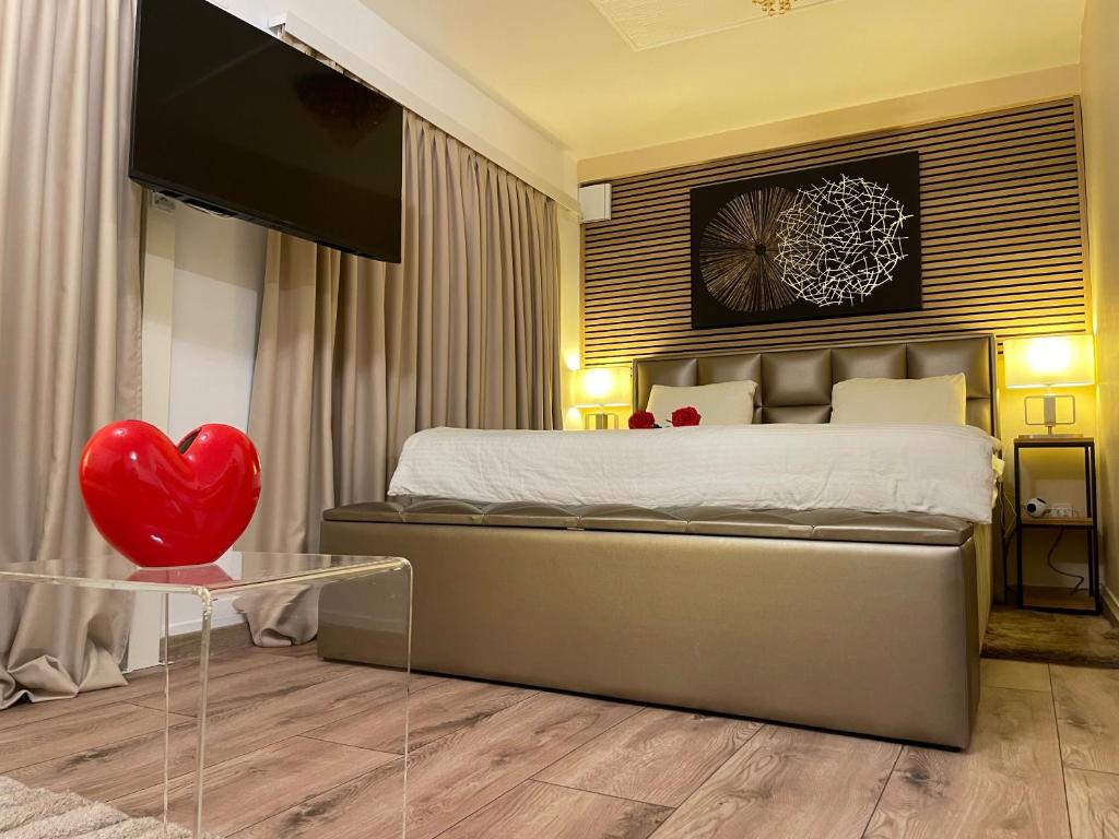 a bedroom with a bed with a heart on it at Apartman Jacuzzi Be Happy in Zagreb
