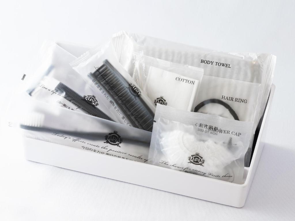 a white box filled with black and white toothbrushes at APA Hotel Shibuya Dogenzakaue in Tokyo