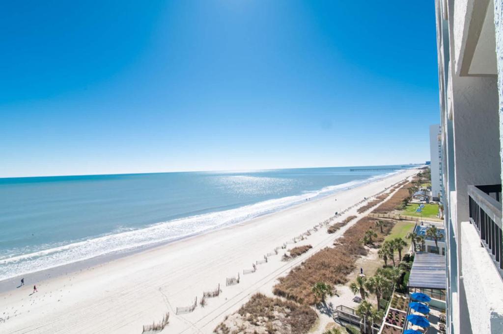 a view of the beach from the balcony of a building at Ocean Front Escape with Lazy River in Myrtle Beach