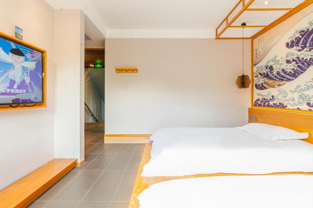 Letto o letti in una camera di Shenzhen Yusu Linting Seaview Inn Judiaosha Branch