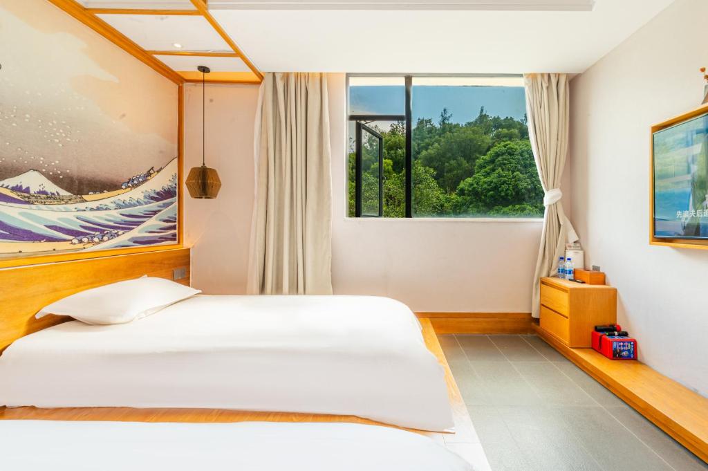 Letto o letti in una camera di Shenzhen Yusu Linting Seaview Inn Judiaosha Branch