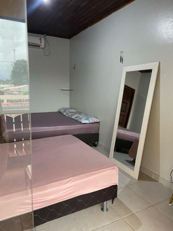 a room with two bunk beds and a mirror at Cop30 aluguel in Belém