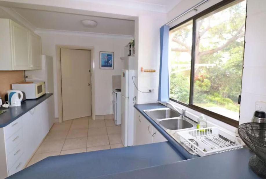 a kitchen with a sink and a window at 14 Broome Street in Mallacoota