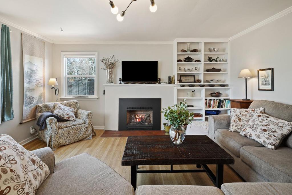 a living room with a couch and a fireplace at NW Nest 30 Day Minimum in Bend
