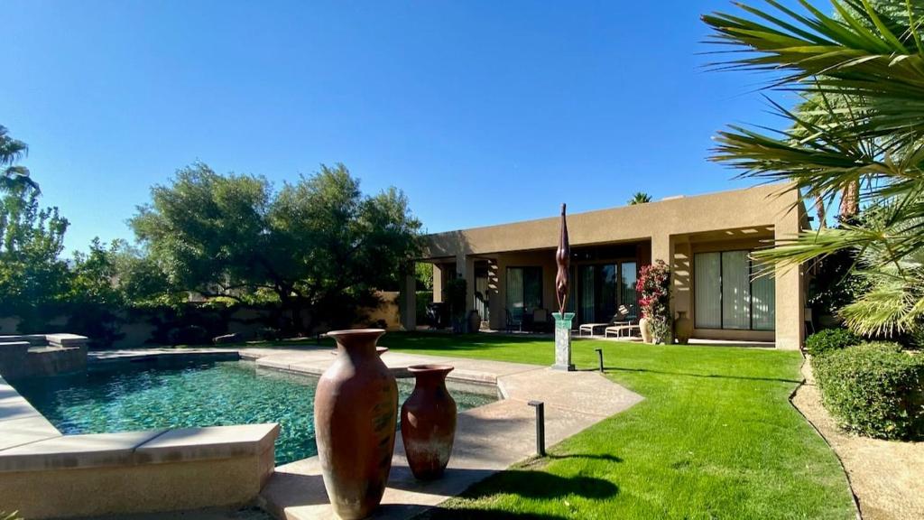 two large vases sitting in front of a house at Double Eagle in Rancho Mirage