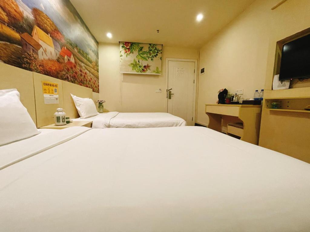 Postel nebo postele na pokoji v ubytování EMi Hotel Guangzhou International Convention and Exhibition Center Guangzhou Tower Branch