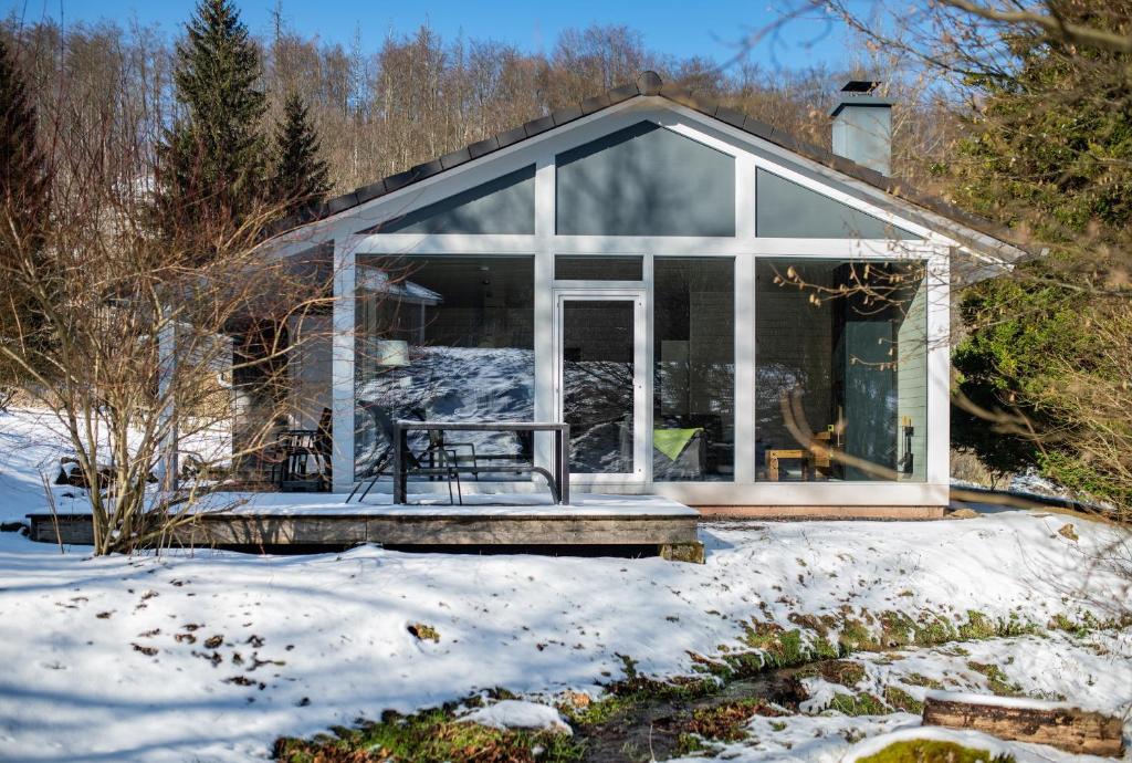 a small house in the snow with a porch at 2 bis 4 Personen F2H1 in Ruhla