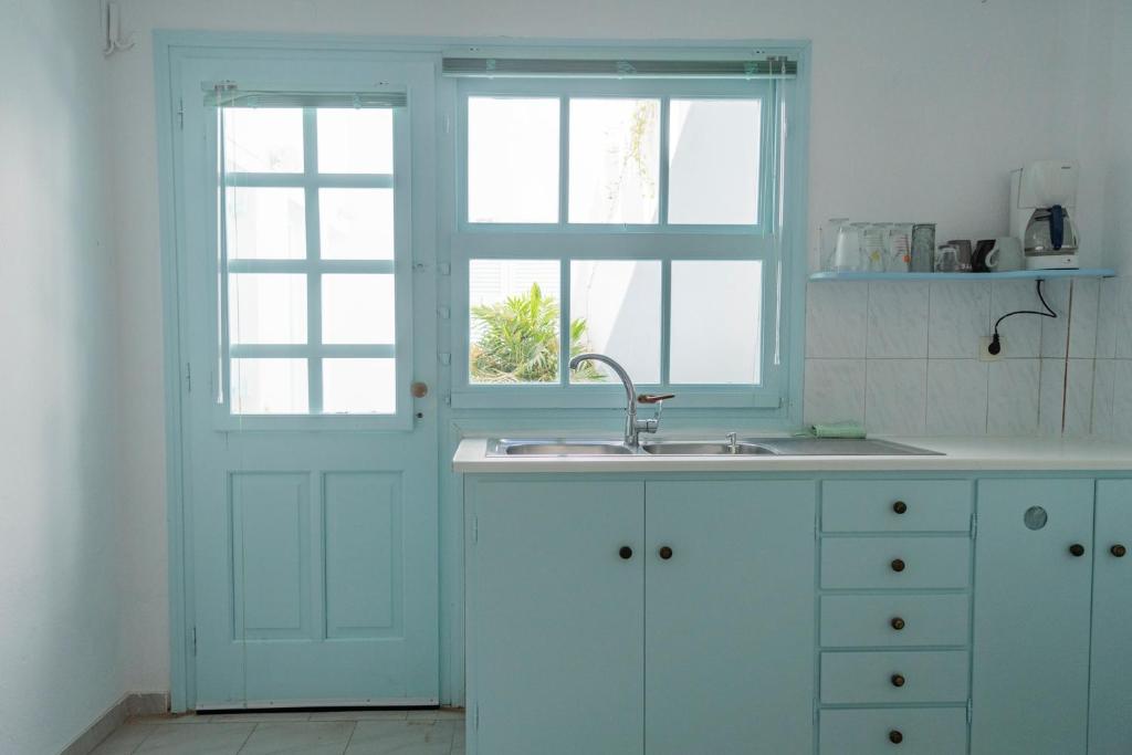 a kitchen with a sink and a window at Paroscarmel studio-apartment in Logaras