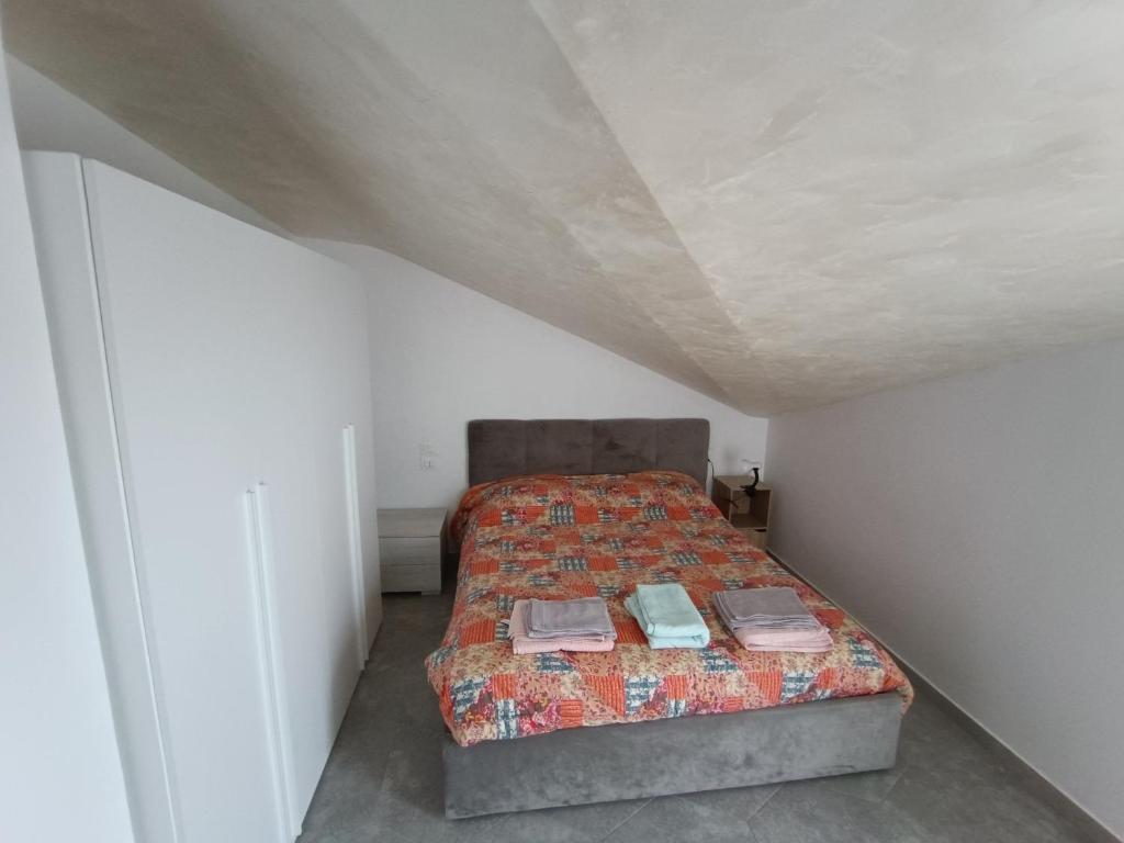 a bedroom with a bed in a white room at Casa vasto via croci in Marina di Montenero