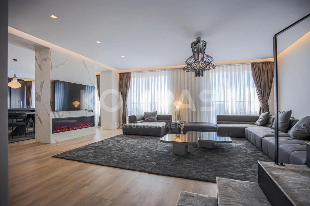 a living room with a couch and a table at Presidental Suite in Luxury Hotel at City Center in Pristina