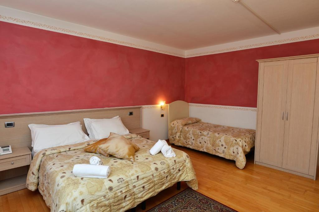 Postel nebo postele na pokoji v ubytování Hotel Marianna