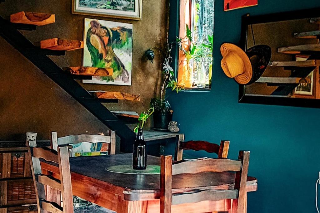 a dining room with a table with a bottle of wine at Coruya Wild in Santa Ana