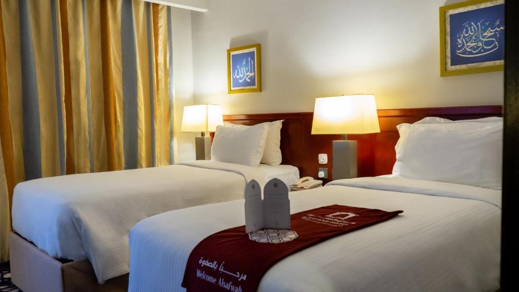 Postel nebo postele na pokoji v ubytování فندق الصفوة البرج الثالث Al Safwah Hotel Third Tower 3