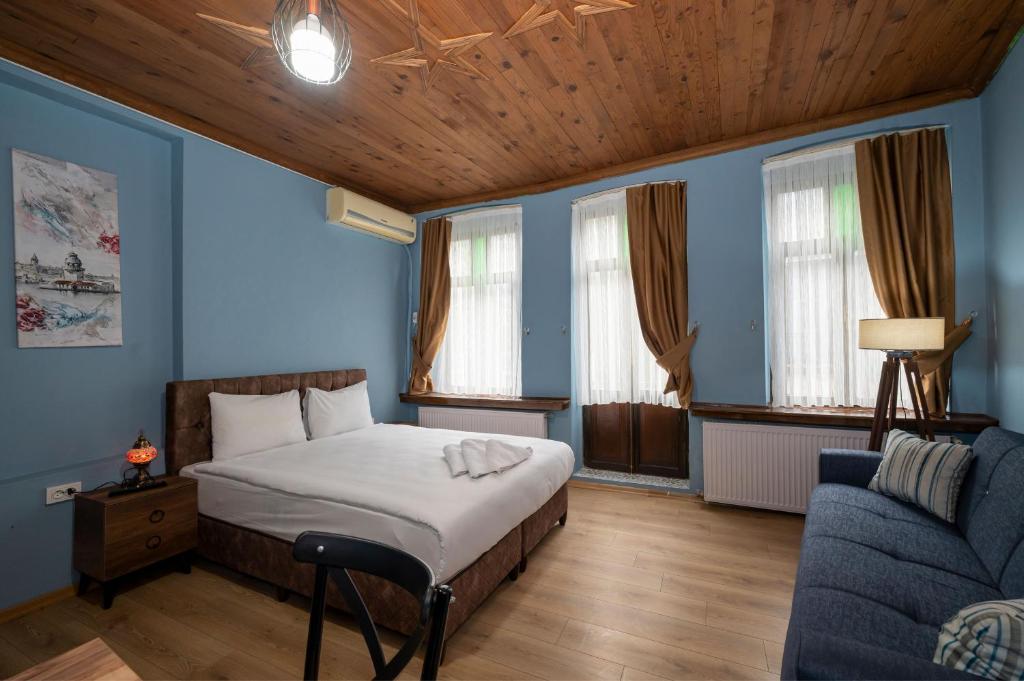 a bedroom with a bed and a couch at TaksimAntiqueOtel in Istanbul