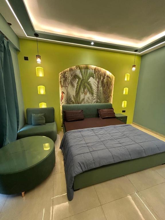 a bedroom with a bed and a couch and a chair at Leisure homes in Lucknow