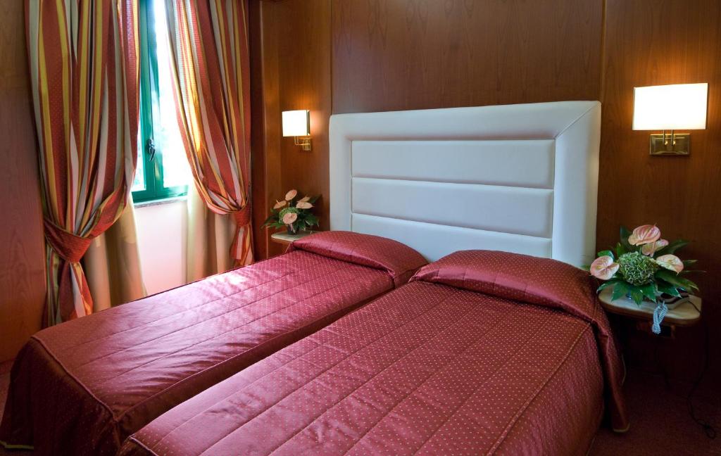 Postel nebo postele na pokoji v ubytování AS Hotel Monza