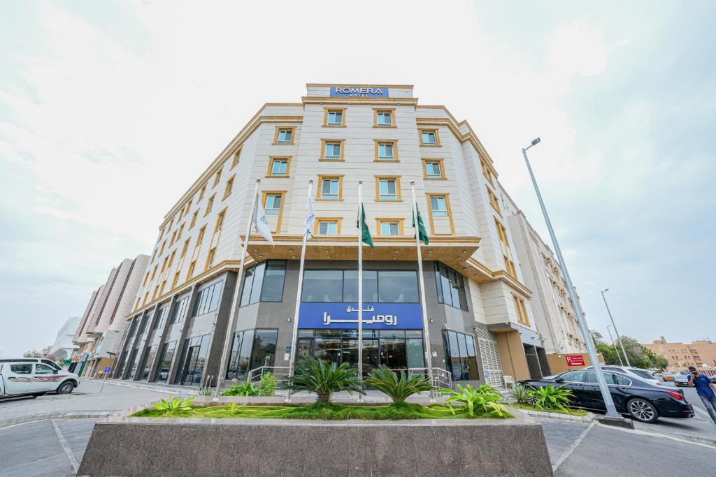 a tall building with a sign on top of it at Romera Hotel in Jeddah