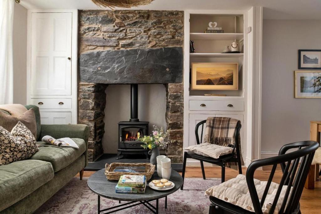 a living room with a couch and a fireplace at Finest Retreats - Bwthyn Llechi, Slate Cottage in Blaenau-Ffestiniog
