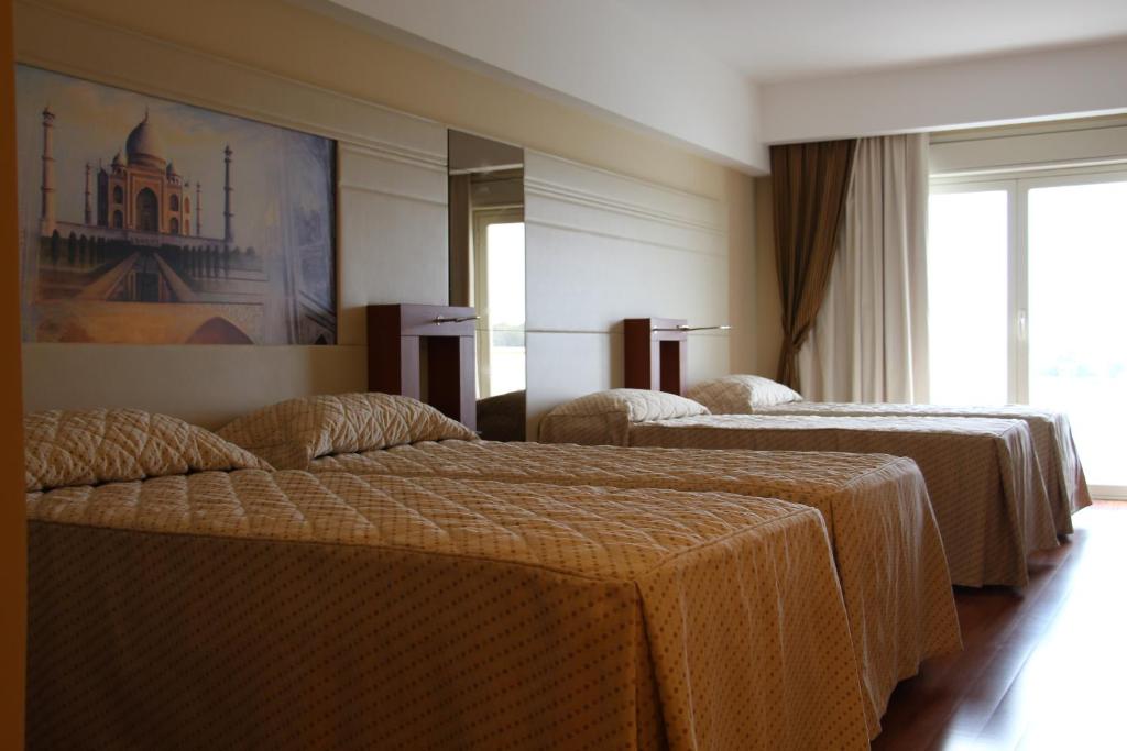 Postel nebo postele na pokoji v ubytování Catania International Airport Hotel