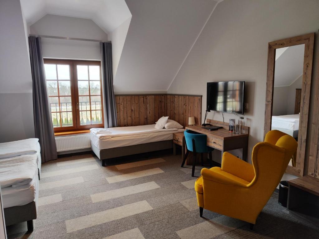 Postel nebo postele na pokoji v ubytování Hotel Nowa Holandia