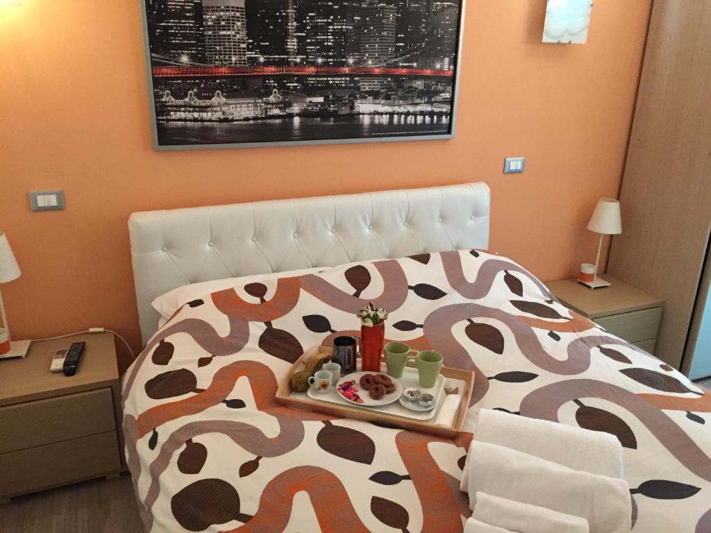 a bedroom with a bed with a tray of food on it at B&B SPQR in Rome