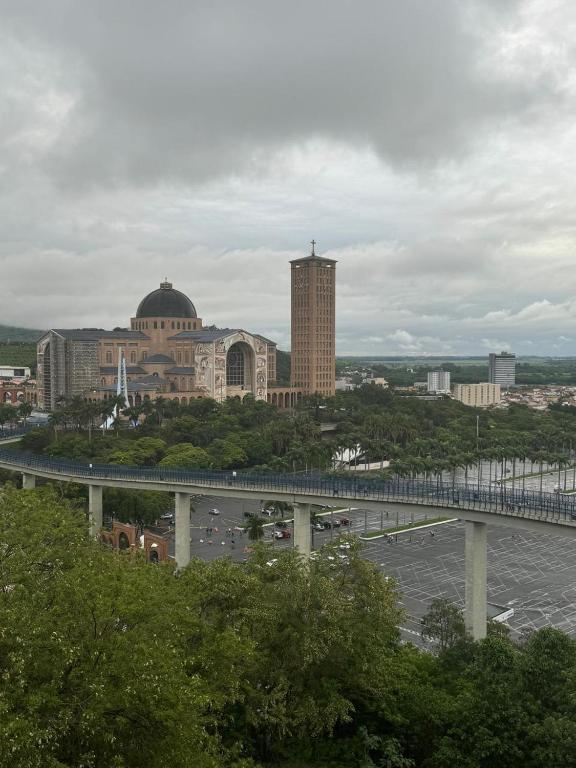 a bridge over a river in a city with buildings at Imperial Hotel in Aparecida