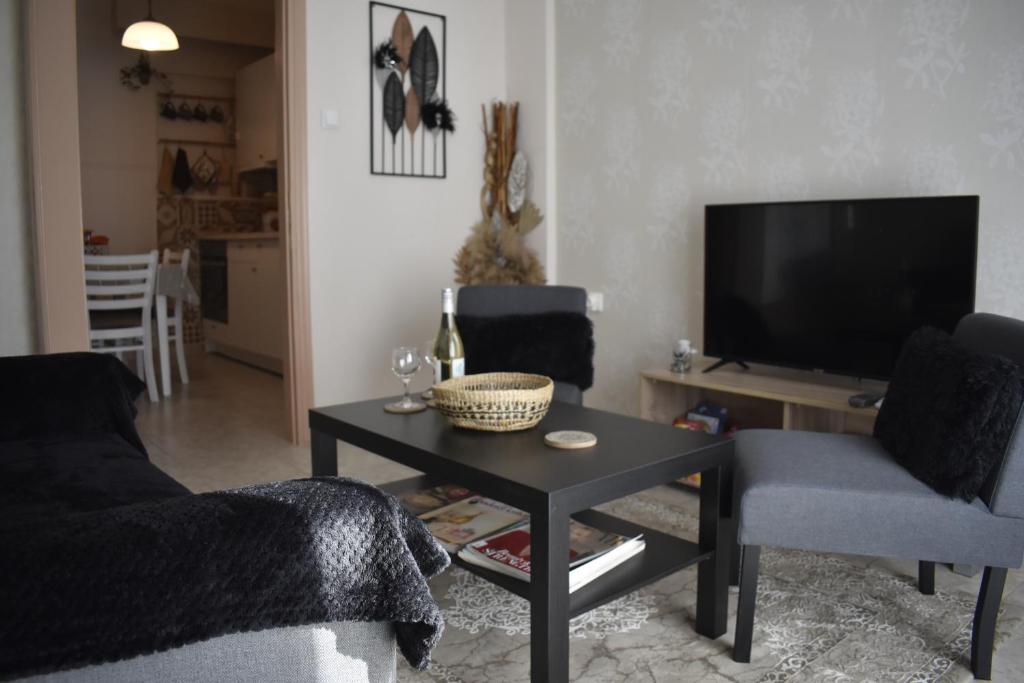 a living room with a couch and a table at Floor in Alexandroupoli