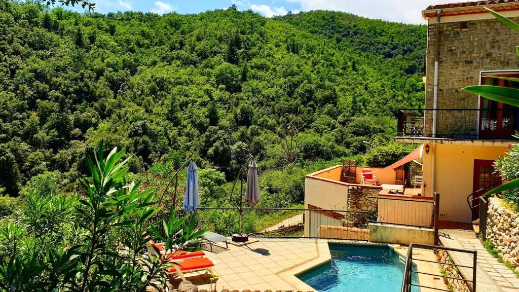 une maison avec une piscine en face d'une montagne dans l'établissement Casa Sola Apartment, stunning views, private pool, à Arles-sur-Tech