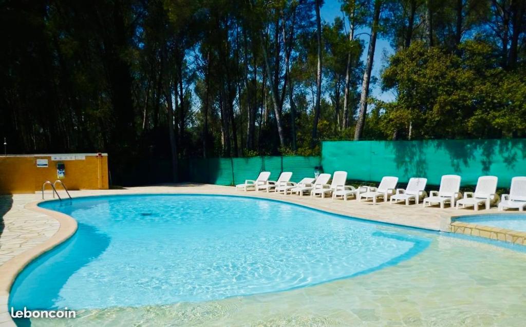 une piscine avec des chaises longues et une piscine dans l'établissement Les Cystes, à Sanary-sur-Mer