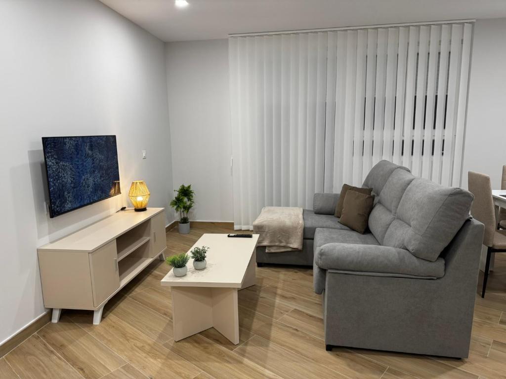 a living room with a couch and a table at Apartamentos La Paz in Ibi