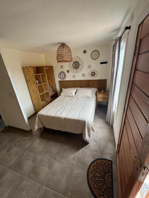 a bedroom with a bed and a table and a window at Cabañas Boutique La Soñada in Fiambalá