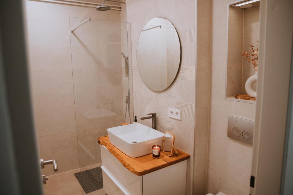 a bathroom with a sink and a mirror at Apartman Esseg - Luxury Living in Historic Esseg - SELF CHECK IN in Osijek
